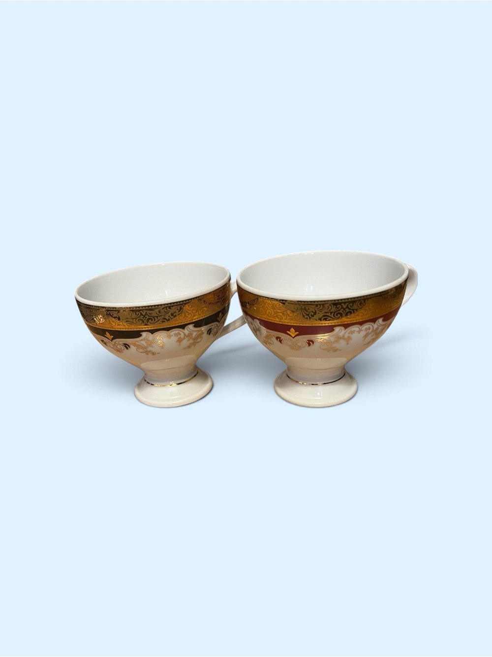 Pair of White and Gold Footed Porcelain Cups with Ornate Banding